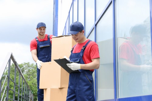Local moving team handling boxes and furniture in West London