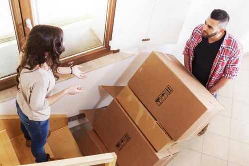 Professional movers handling office relocation items in a commercial setting